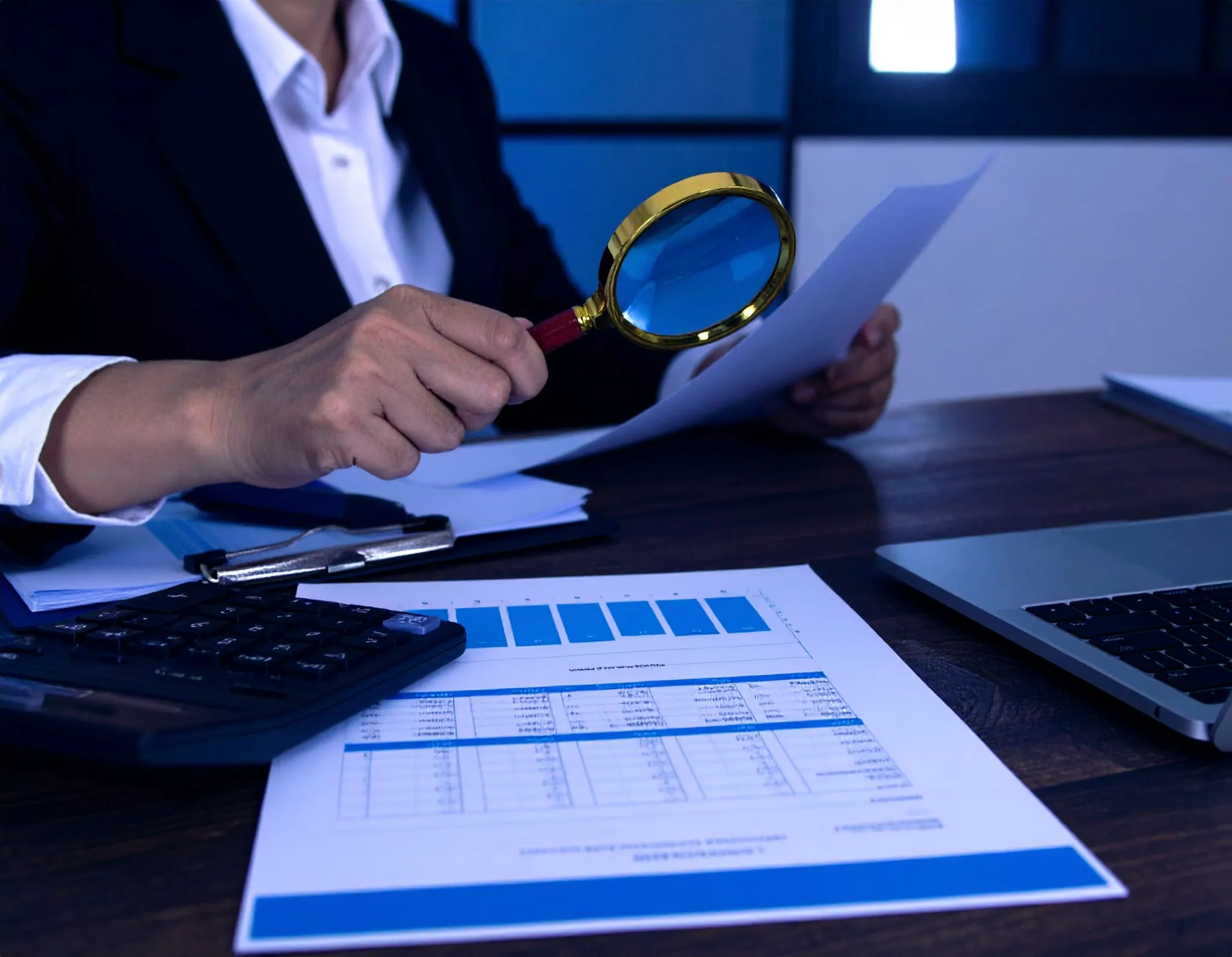 Tax Risk Management & Compliance services. An accountant looking at financial data