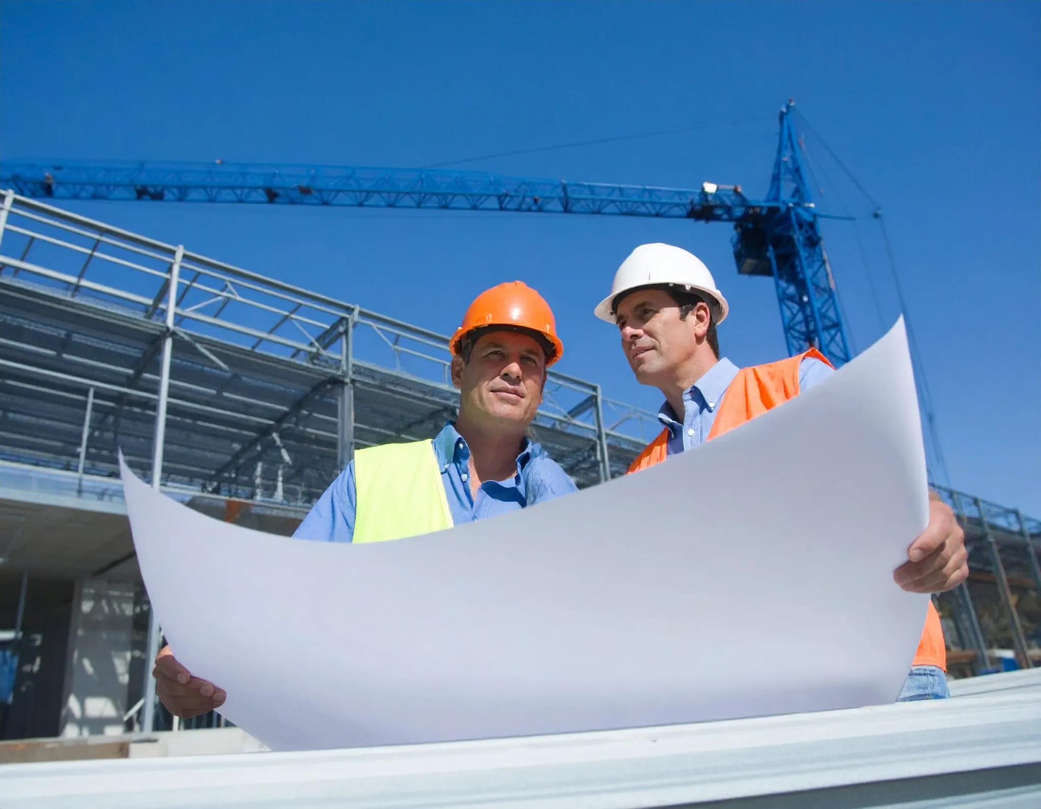CIS - Construction Industry Scheme. Workers holding up drawings